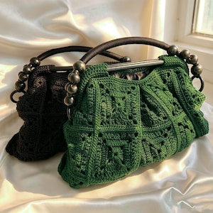May include: Two crochet handbags, one in dark green and one in black, featuring a square-patterned texture. Each bag has a curved handle adorned with large, round, dark-colored beads and a frame closure, showcasing a structured yet soft design.
