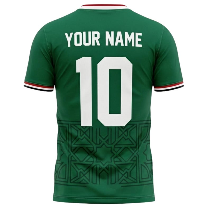 May include: Green soccer jersey with the number 10 in white. The jersey has the text "YOUR NAME" above the number. The jersey has a geometric pattern at the bottom and red and black trim on the sleeves and collar.