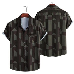 May include: Short-sleeved button-down shirt with a geometric pattern in shades of brown and green. The shirt has a chest pocket and white trim on the sleeves and collar. The back of the shirt is also visible.