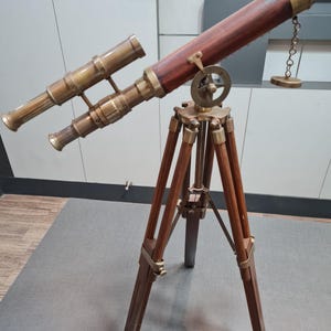 Telescopio antiguo de latón con trípode de madera: decoración náutica clásica