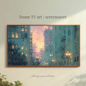 May include: A framed art print depicting a city street scene at dusk. The buildings are painted in shades of teal and blue, with warm orange and pink hues in the sky. The text "frame TV art / screensaver" is at the top.