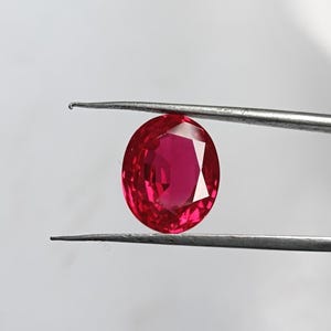 12 CT Oval Lab Grown Ruby: Red Faceted Gemstone, 14.3x11.7 MM