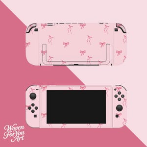 May include: A light pink gaming console skin featuring a repeating pattern of small, delicate pink bows. The skin covers the back of the console and the front faceplate, including the area surrounding the screen and the controller buttons.