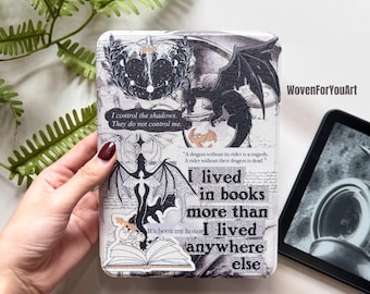 May include: A white and gray e-reader cover with a dragon and book design. The cover features text that reads "I control the shadows. They do not control me." and "I lived in books more than I lived anywhere else."