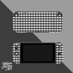 May include: A black and white gingham patterned Nintendo Switch console and a separate top cover. The console has a black screen and buttons. The top cover is rectangular with the same gingham pattern. The words "Woven For You Art" are in the bottom left corner.