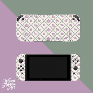 May include: A Nintendo Switch console and dock, decorated with a floral design. The pattern includes lavender flowers and green vines on a cream backdrop. The text "Woven For You Art" is visible in the lower left corner.