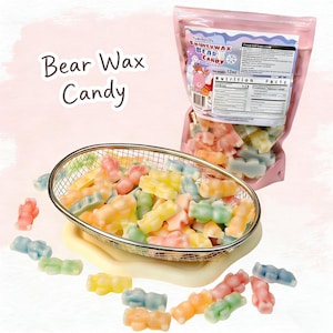 May include: A clear bag of Fruity Wax Bear Candy, with a pink label, next to a metal basket filled with colorful gummy bear-shaped candies. The candies are in various pastel colors, including pink, yellow, green, and blue. Text on the bag reads "Bear Wax Candy".