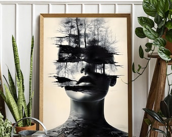 May include: A framed art print featuring a black and white surrealist portrait. The image depicts a woman's face with a landscape of trees and water integrated into the design. The artwork is displayed in a light brown wooden frame.