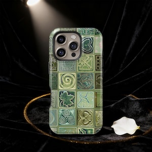 May include: A green and beige phone case with a mosaic tile design. The case features a variety of square tiles with different patterns, including leaves, swirls, and geometric shapes. The phone case has a glossy finish and a camera bump.