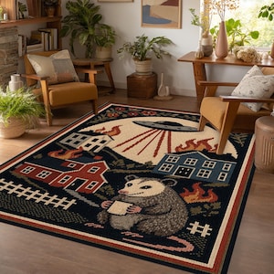 May include: A rectangular area rug featuring a dark blue background with a central illustration of a possum holding a small white square. The scene includes a large cream moon, a flying saucer with light beams, burning houses, and a white fence.