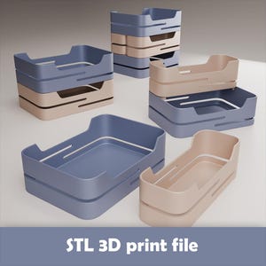 May include: Several stacks of blue and beige rectangular trays with curved handles are displayed. The trays have a modern design with a smooth finish. The text "STL 3D print file" is at the bottom of the image.