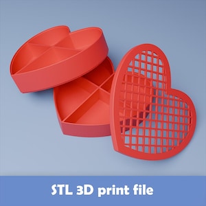 Puede incluir: Caja roja en forma de corazón con tapa de celosía y divisores internos. La caja está abierta, revelando los compartimentos. El texto "STL 3D print file" está en la parte inferior de la imagen. La caja es probablemente para almacenamiento u organización.