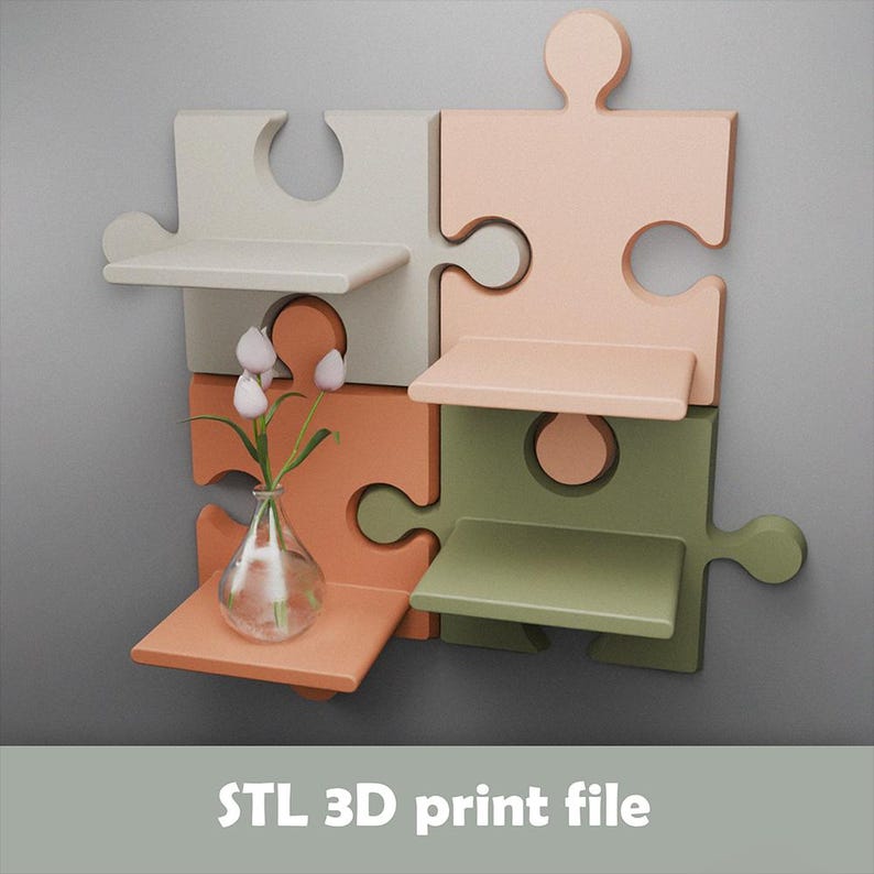 May include: A multi-colored puzzle-shaped wall shelf with four pieces in shades of white, peach, orange, and green. Each piece has a small shelf. A clear vase with white flowers sits on one shelf. The text "STL 3D print file" is at the bottom.