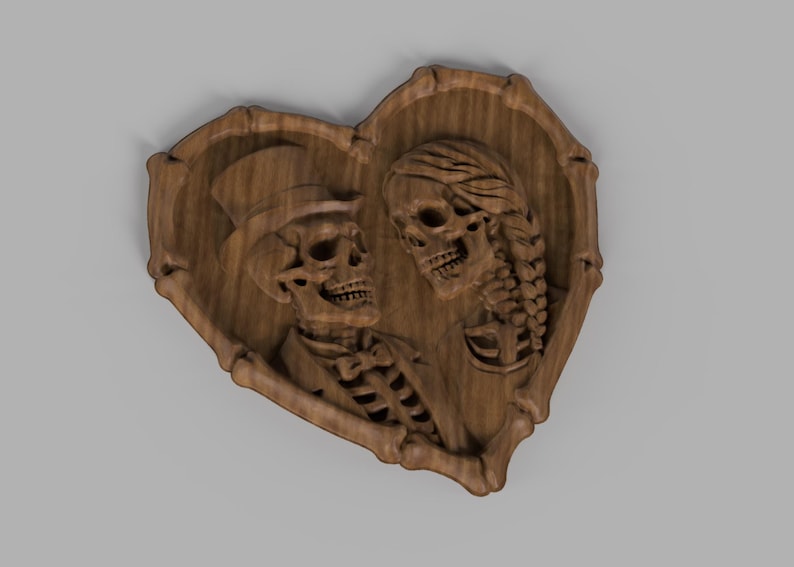 May include: A wooden heart-shaped plaque with a carved design of two skeletons. One skeleton wears a top hat and bow tie, the other has braided hair. The artwork is made of light brown wood.