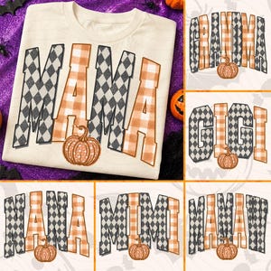 May include: A cream-colored t-shirt featuring the word MAMA in large block letters with a black and white diamond pattern and an orange and white buffalo plaid pattern, accented by a graphic of an orange pumpkin at the base of the letters.