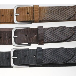 May include: Three belts in tan, dark brown, and black, each featuring a silver-toned metal buckle, a textured ribbed section near the buckle, and a diamond-patterned embossed finish along the length of the strap with visible adjustment holes.