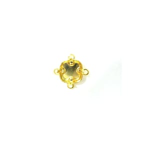 May include: A gold-colored jewelry finding with a square shape and rounded edges. It has four loops for attaching to other components and a small, recessed center. The finding is likely used in jewelry making or crafting.