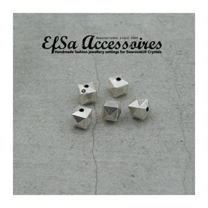 Könnte beinhalten: Fünf silberfarbene, geometrische Perlen mit facettierten Oberflächen und kleinen Löchern. Die Perlen sind auf einer grauen Oberfläche verstreut. Der Text "Elsa Accessoires" steht oben, mit dem Slogan "Handmade fashion jewellery settings for Swarovski® Crystals."