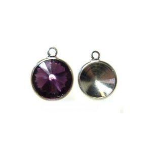 May include: Two round pendants. One pendant features a faceted, deep purple crystal set in a silver-tone metal bezel. The other pendant is a silver-tone metal disc with a loop at the top for hanging. Both pendants are on a white background.