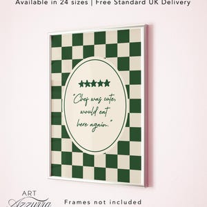 May include: Framed art print with a green and white chequered background. The print features an oval shape with the text "Chef was cute, would eat here again." and five star icons. The artwork is framed in a silver border.