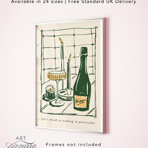 May include: Framed art print with a green wine bottle, champagne glass, and candles. The artwork has a cream background with green line art and the text "Let's drink to nothing in particular." The word "Wine" is on the bottle.