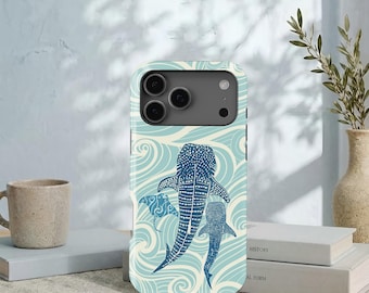 May include: A smartphone case featuring a light blue and cream-colored wave pattern background with two dark blue whale sharks and a manta ray illustration. The case has a rectangular camera cutout at the top with three circular lenses visible.