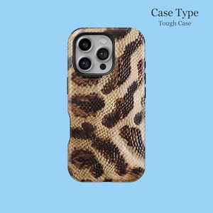 May include: A tough phone case with a snakeskin pattern in shades of brown and tan. The case has a textured appearance and features cutouts for the phone's camera and buttons. The words "Case Type" and "Tough Case" are printed on the top.