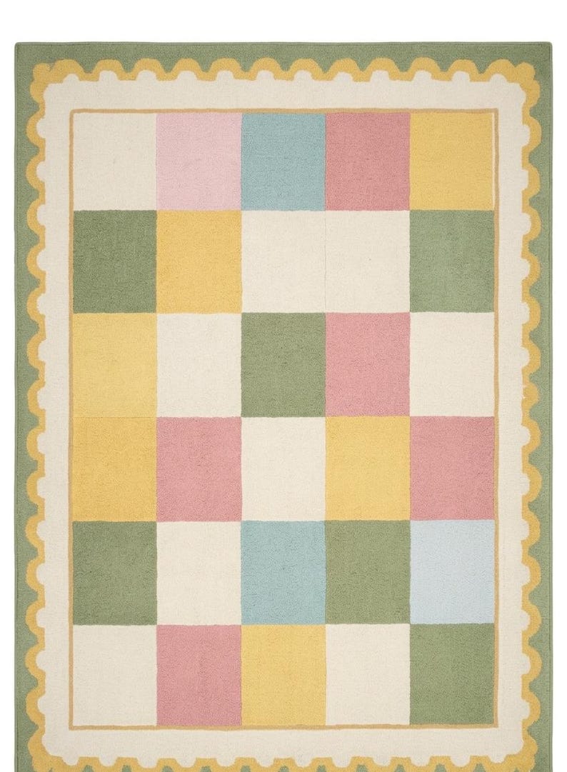 Soft plush pastel checkerboard nursery rug with scalloped border in blush pink, sage green, cream, butter yellow, and baby blue tones. This tufted kids room carpet is styled in a dreamy rainbow-themed nursery and adds cozy cottagecore charm to playrooms, baby rooms, and modern children’s spaces. Perfect for pastel aesthetic decor, soft nursery interiors, Montessori playrooms, and colorful bedroom styling for toddlers and babies