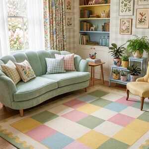Soft plush pastel checkerboard rug with scalloped border in blush pink, sage green, cream, butter yellow, and blue tones. This tufted room carpet is styled in a dreamy rainbow-themed and adds cozy cottagecore charm to  cute corners, baby rooms, and modern spaces. Perfect for pastel aesthetic decor, soft nursery interiors, Montessori playrooms, colorful bedroom and living rooms