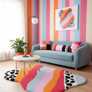 Irregular blob shaped pastel stripe rug with black and white cow print detail