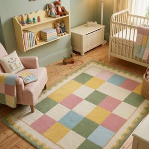 Soft pastel checkerboard nursery rug with scalloped border in pink, sage green, cream, yellow, and baby blue, styled in a cozy rainbow-themed kids room with plush tufted texture.