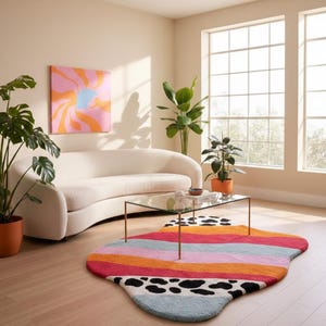 Irregular blob shaped pastel stripe rug with black and white cow print detail placed in living room