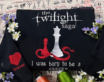 May include: Black sweatshirt with white and red embroidered design. Features the text "the twilight saga" and "I was born to be a vampire." Includes a red heart with the word "forever" embroidered on the sleeve.