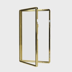 May include: A gold-colored rectangular frame with a clear, transparent center. The frame is open, with one side slightly ajar, revealing the interior. The design is sleek and modern, with a polished finish.