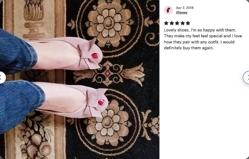 May include: A pair of pink ballet flats with a bow on the toe. The shoes have a red accent on the bow. The shoes are on a patterned rug.