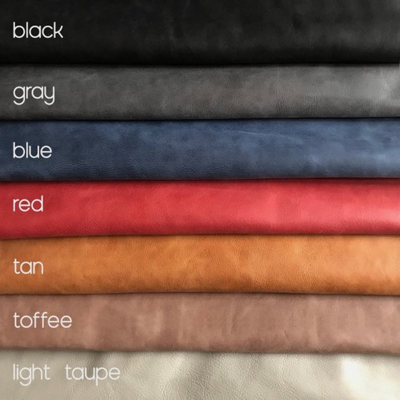 May include: A stack of seven different colored leather swatches, from top to bottom: black, gray, blue, red, tan, toffee, and light taupe.