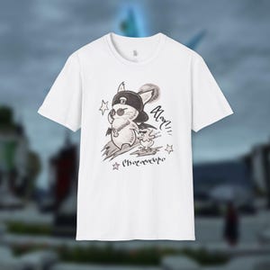 May include: White t-shirt featuring a black and white illustration of a mouse wearing a hat and sunglasses, with a small bird. The design includes text and stars. The shirt has short sleeves and a crew neck.