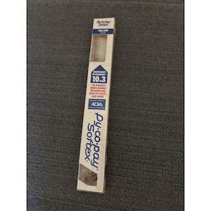 May include: A Py-co-pay Sortex toothbrush in its original packaging. The packaging is white with blue accents and features the text "FULL SIZE" and "COEFFICIENT OF CLEANING 10.3". The packaging also includes the ADA seal.