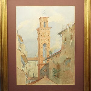 May include: Watercolor painting of a European cityscape featuring a tall, brick bell tower. The artwork, framed in gold, depicts buildings with terracotta roofs and a cloudy sky. The painting is signed in the lower right corner.