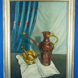 May include: Oil painting in a silver frame depicting a still life. A copper pitcher with a gold handle and spout is next to a gold mortar and pestle. A white cloth is under the objects, with a blue curtain in the background.