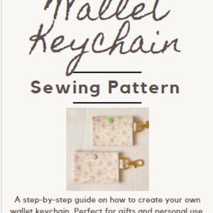 May include: A sewing pattern for a wallet keychain. The image shows two finished keychains with floral fabric, snap closures, and gold-colored hardware. The text at the top reads "Wallet Keychain Sewing Pattern."