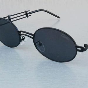 Cartier Black Frame Oval Unisex Sunglasses