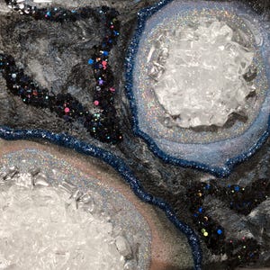 May include: A set of three ceramic mugs with a speckled, matte finish. The mugs are in shades of cream, light gray, and dark gray. Each mug has a simple, minimalist design, perfect for coffee or tea.