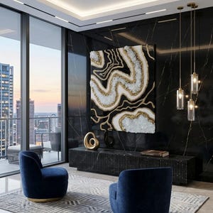 May include: An interior design featuring a large abstract art piece with gold and white accents against a black background. Two navy blue armchairs sit on a patterned rug. The room has large windows and pendant lights.