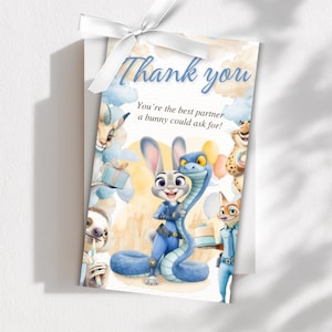May include: A gift tag with a white ribbon features the text "Thank you" and a watercolor illustration of characters from Zootopia. The tag includes Judy Hopps, a blue snake, and other characters, with a light blue and yellow background.