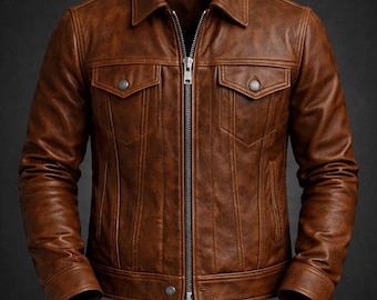 May include: A brown leather jacket featuring a classic collar, a full-length silver-tone metal zipper, and two chest pockets with button-down flaps. The jacket includes vertical seam detailing, long sleeves with buttoned cuffs, and a straight hem.