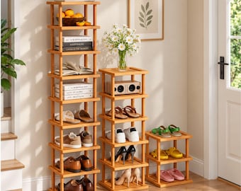 May include: Three light wood shelving units of varying heights. The tallest unit holds fruit, books, and shoes. The middle unit holds a speaker and shoes. The shortest unit holds shoes. Each unit features a square frame design.