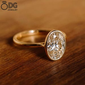 Bezel Set Oval Moissanite Ring: 14K Yellow Gold Solitaire
