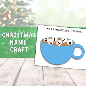 May include: A Christmas-themed craft featuring a blue mug filled with cocoa and marshmallows spelling "OLIVIA." The text "Add the marshmallows to the cocoa" is above the mug. The words "CHRISTMAS NAME CRAFT" are on a green background.