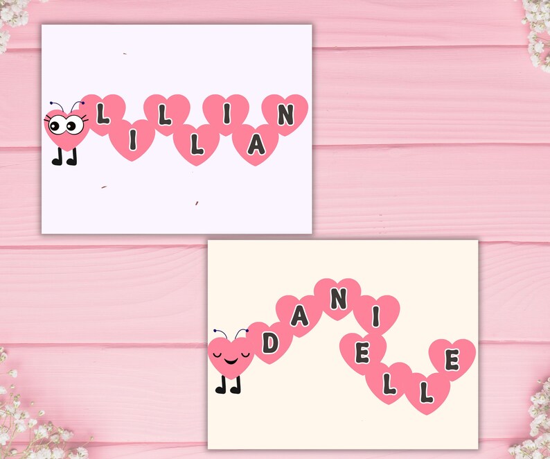 May include: Two cards with pink heart-shaped letters spelling out names. One card says "LILLIAN" with a cartoon butterfly. The other card says "DANIELLE" with a cartoon butterfly. The background is a light pink wooden surface.